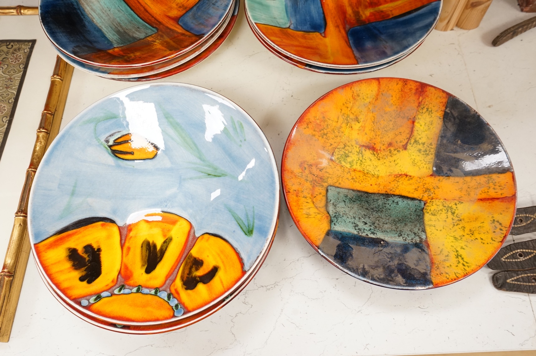 A Poole pottery ‘Gemstones’ fruit bowl and set of five smaller matching dishes, a similar patterned dish and two ‘Wild Poppy’ dishes. Fruit bowl 34cm diameter.